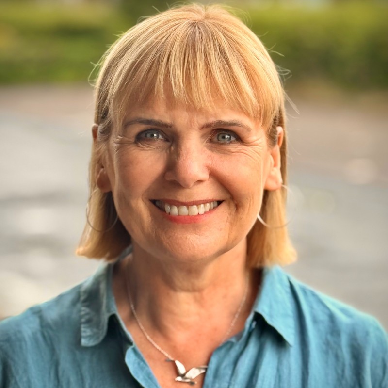 Fiona Sandford, a white woman with blond hair smiles warmly at the camera