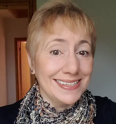 Laura Hughes, white woman with short blonde hair